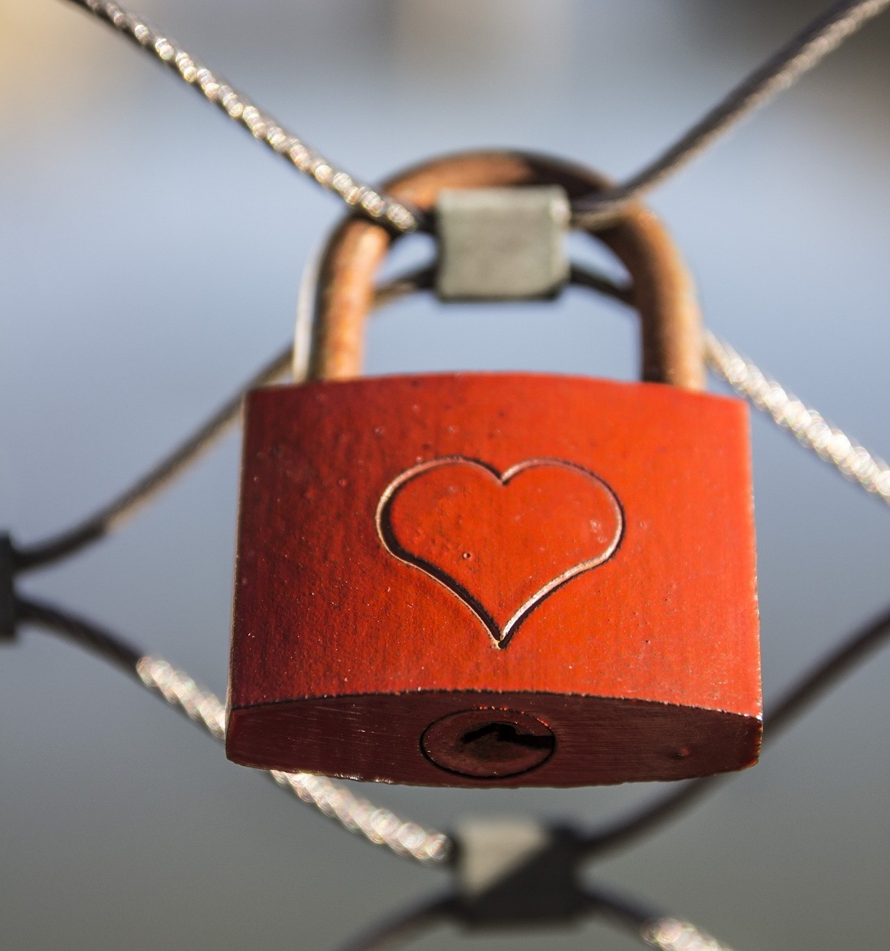 Image of red padlock with heart etched on it