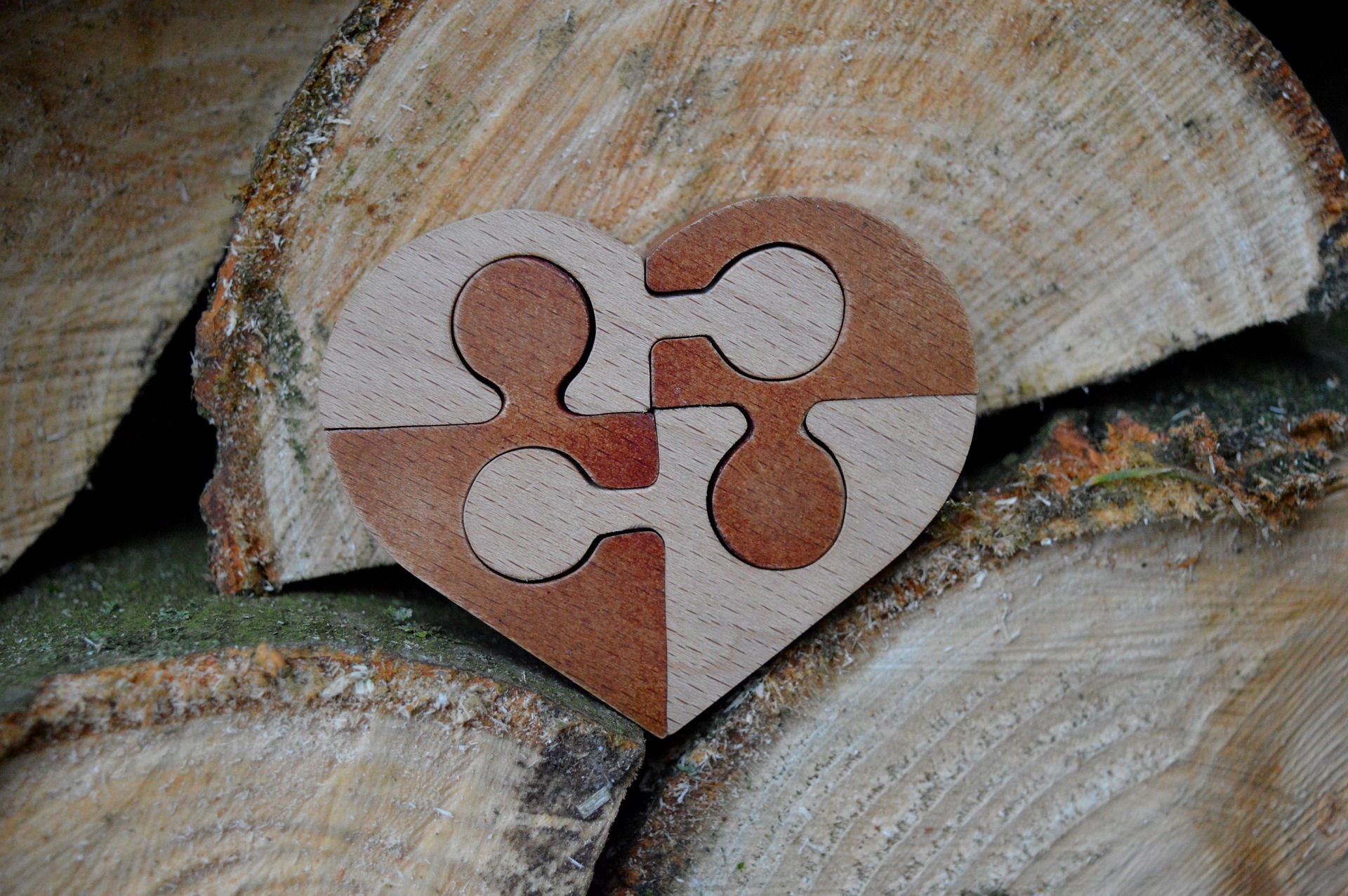 Puzzle pieces formed into a heart and carved out of wood