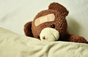 Teddy bear with bandaid on head